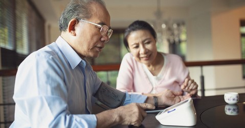 Senior man monitoring his blood pressure at home